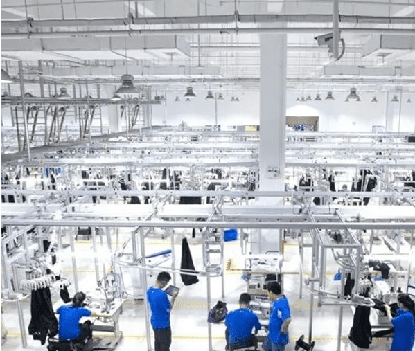 Workers in a large garment factory setting.