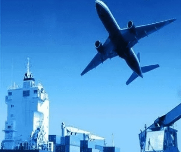 Airplane flying over cargo ship at sea.