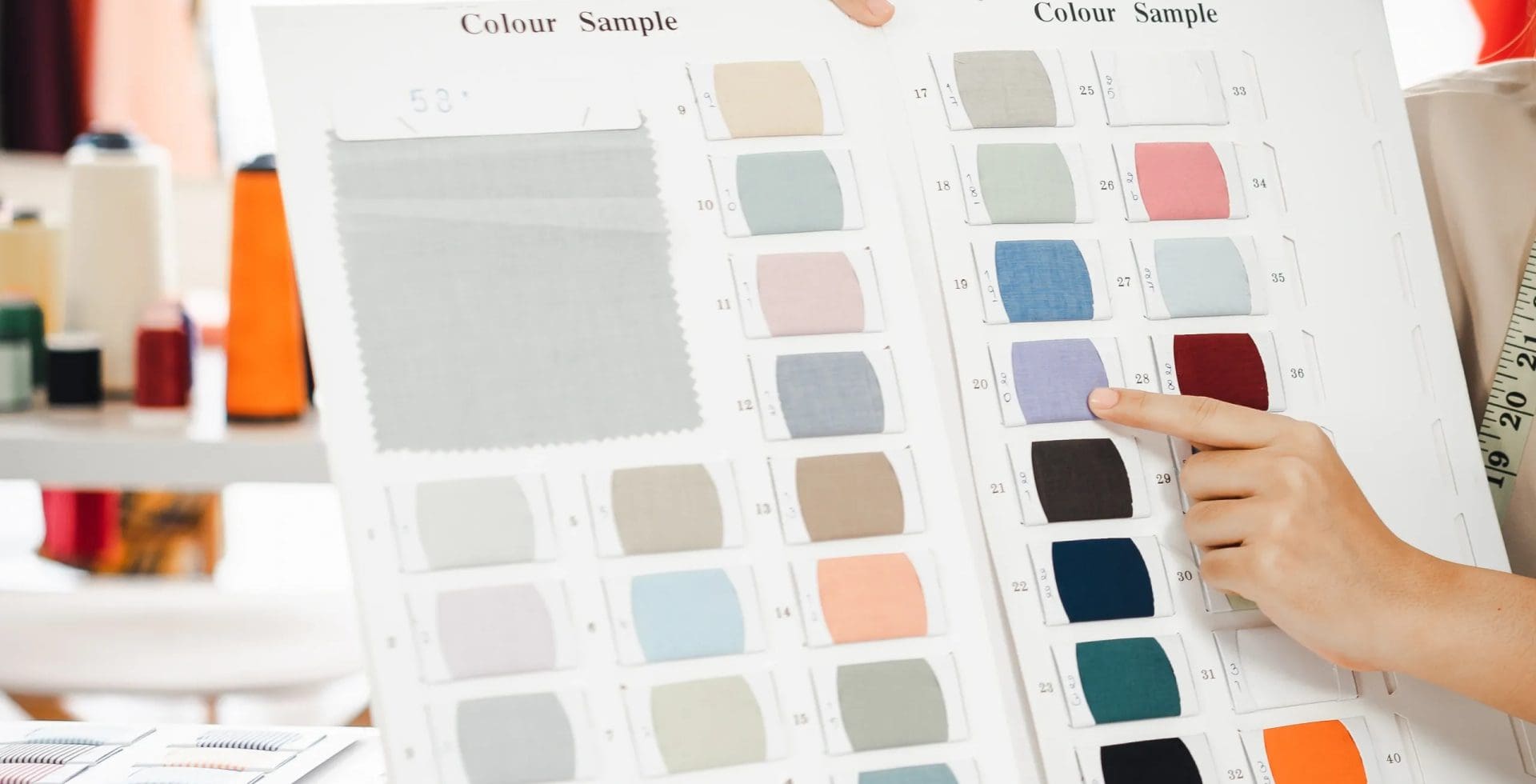 Color samples with person pointing at chart.